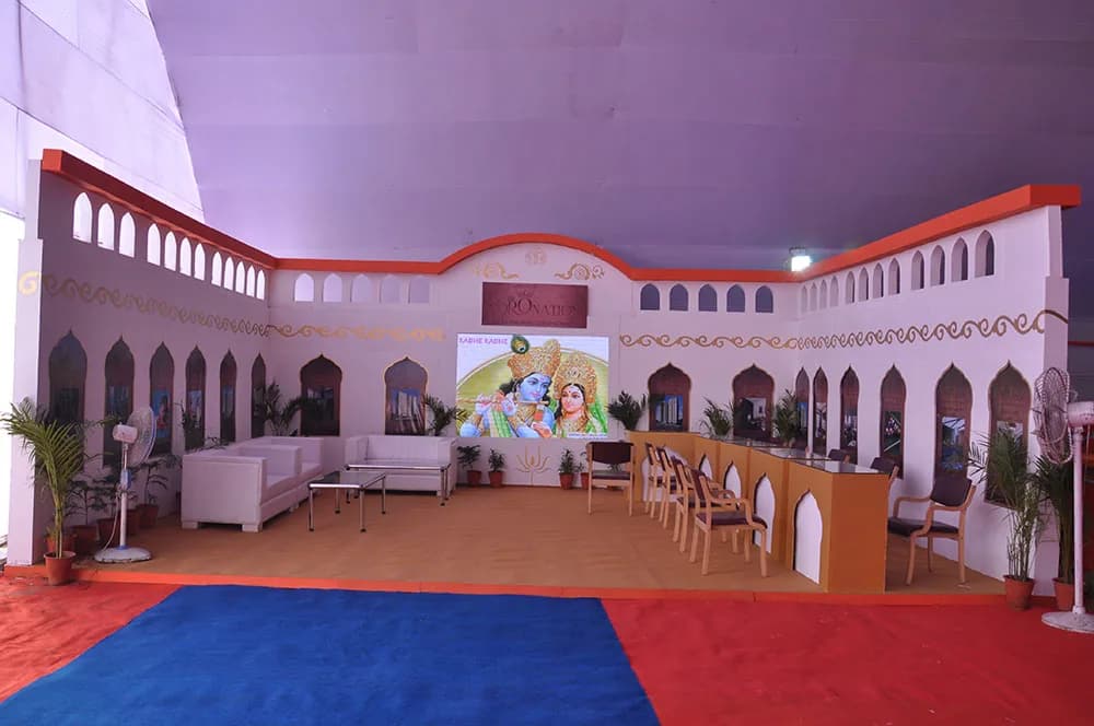 Themed Rajasthani event set with arched walls, lounge seating and a blue carpet