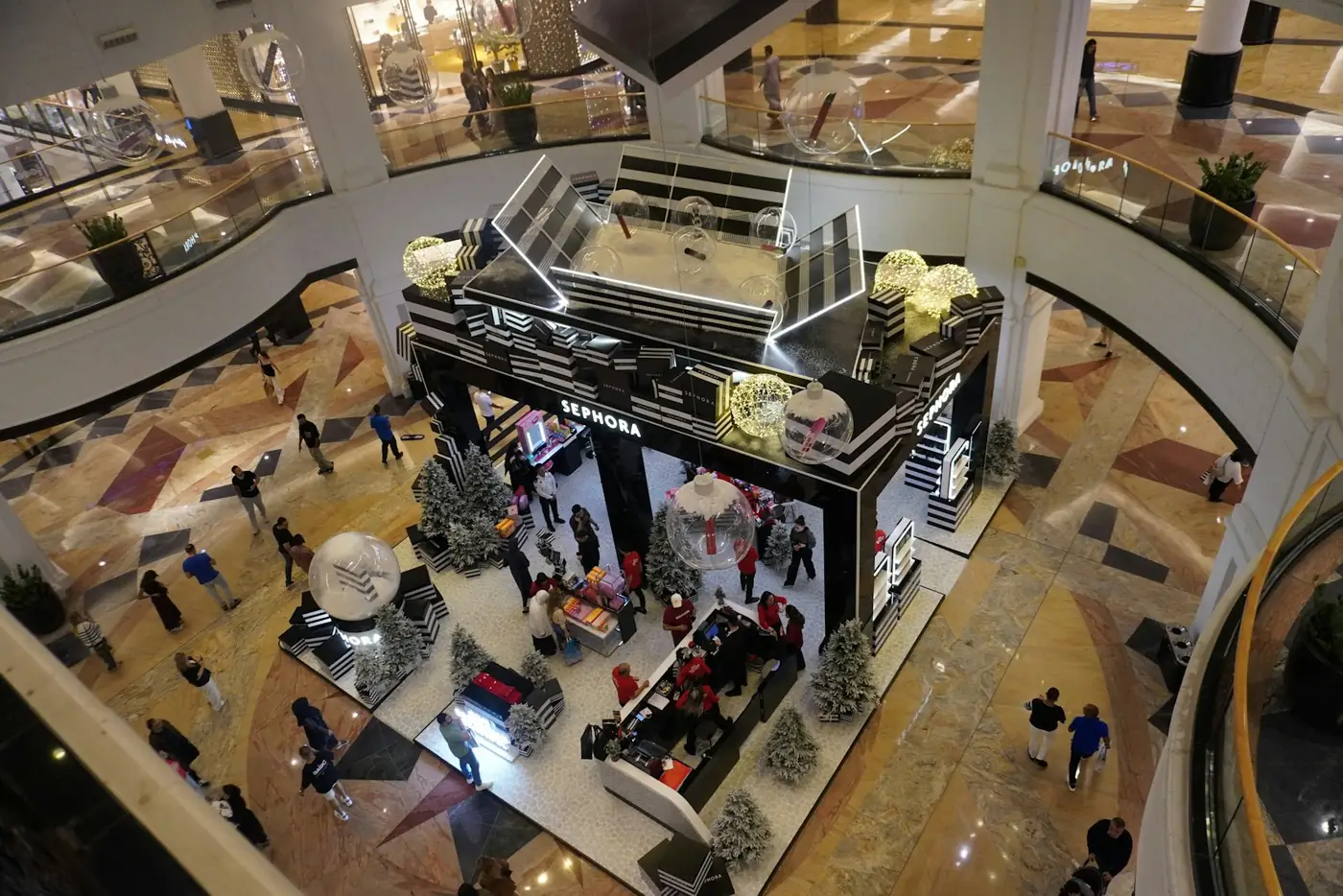 View down into a multi-level shopping mall atrium with display stands